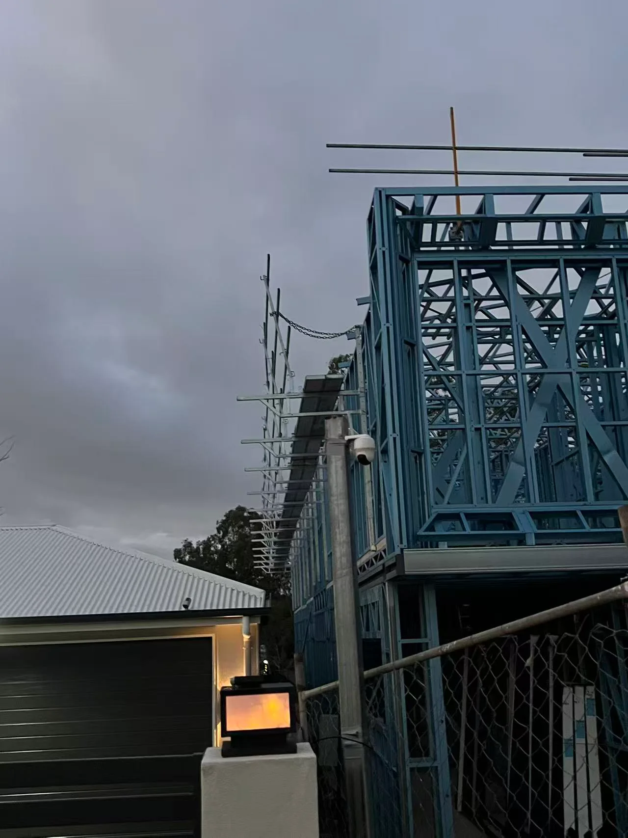 Residential steel framing next to an existing building