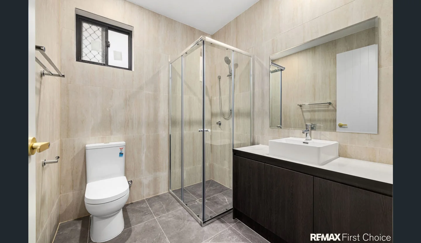 Bathroom fixtures and tiled shower area